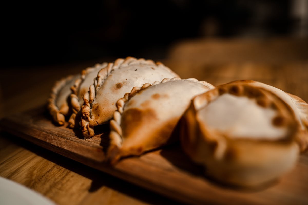 Traditional South American empanadas arranged on a wooden board
