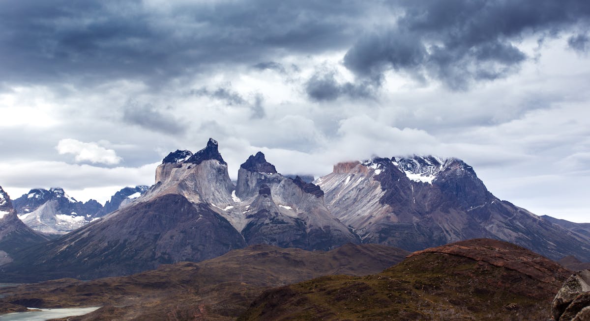 Andes mountains in Torres del Paine with dramatic skies and untouched grasslands