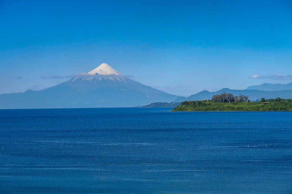 Osorno Volcano towering over Lake Llanquihue under clear blue sky