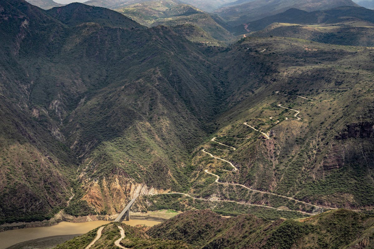 Winding mountain road through dramatic Andes canyon with steep rocky walls