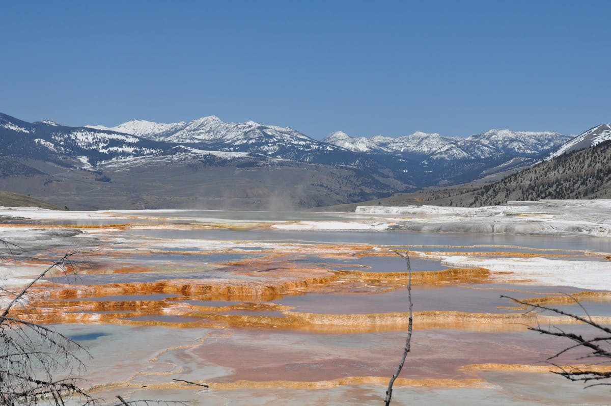 Natural hot spring pools surrounded by rocks in a mountain setting