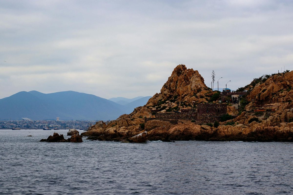 Rocky Chilean coastline with dramatic cliffs meeting the Pacific Ocean