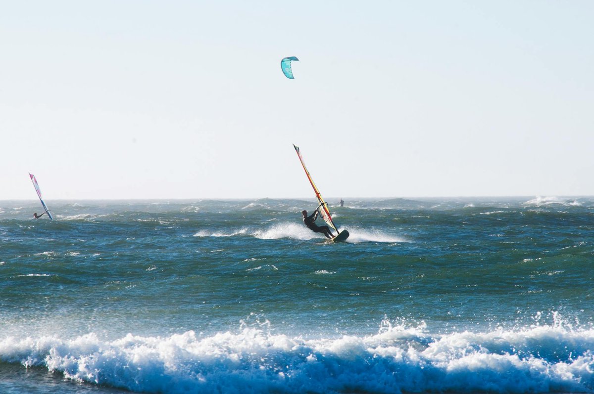 Kitesurfer catching wind above ocean waves along the Chilean coast
