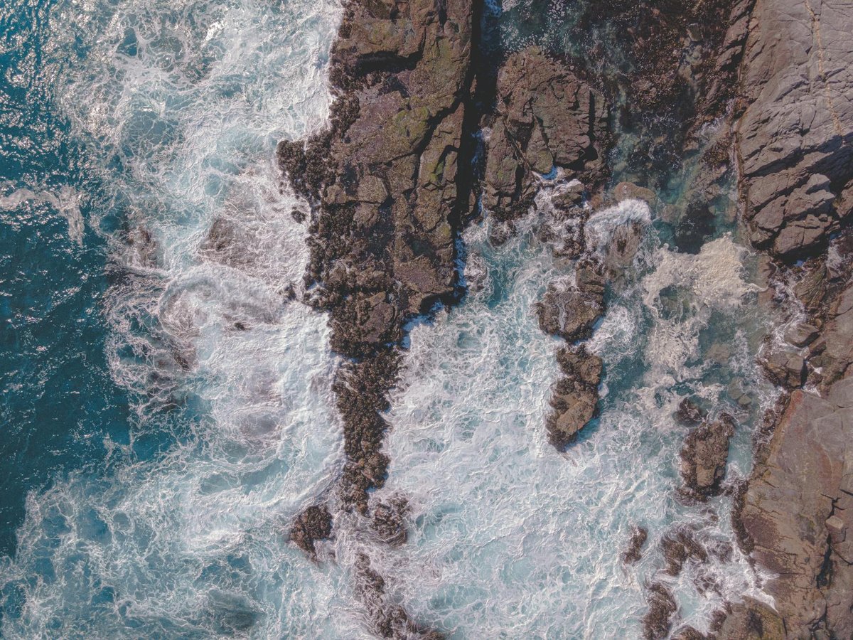 Misty Pacific coastline with waves crashing against rugged Chilean shore