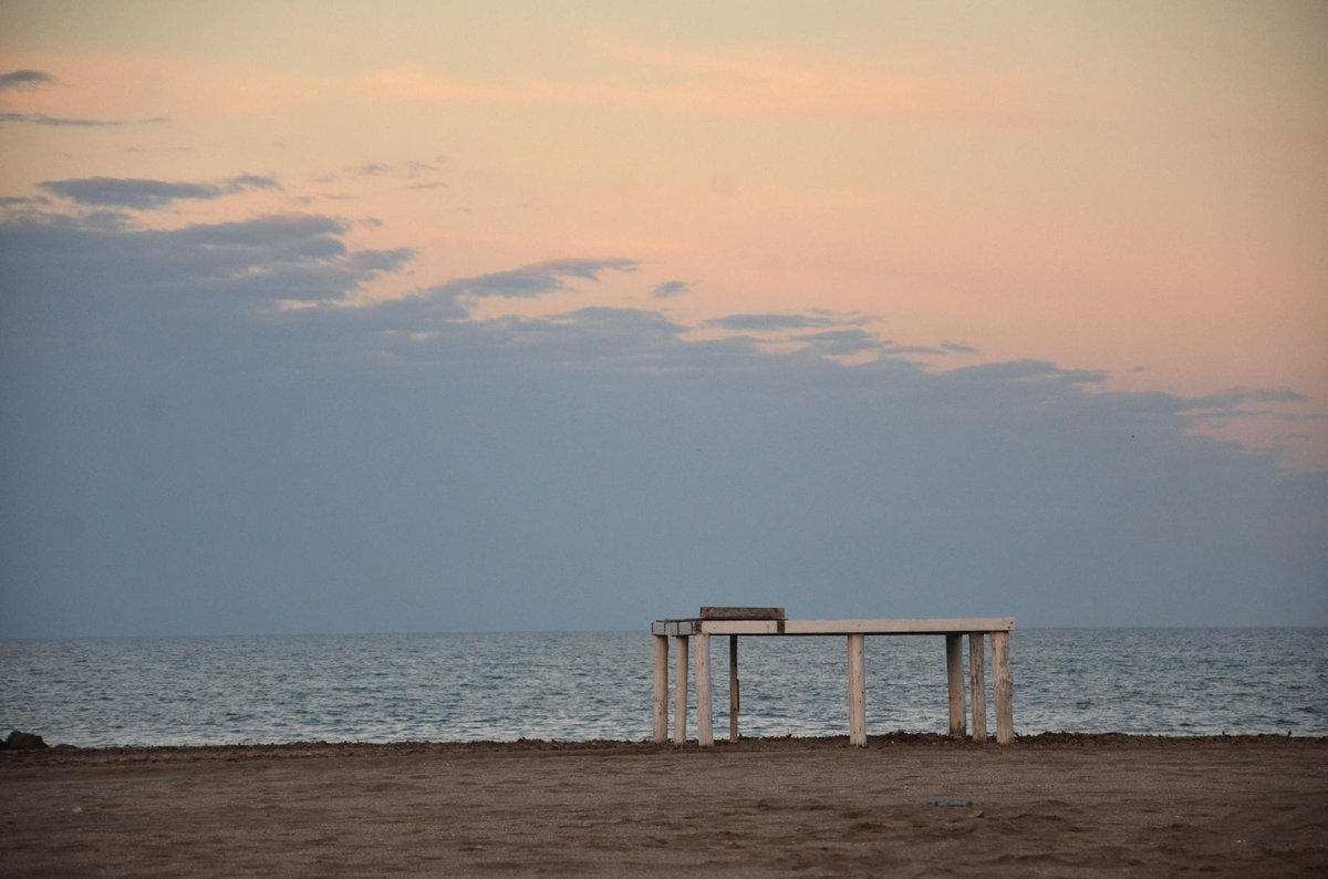 Wide sandy beach in Vina del Mar with coastal buildings and crowded summer scene