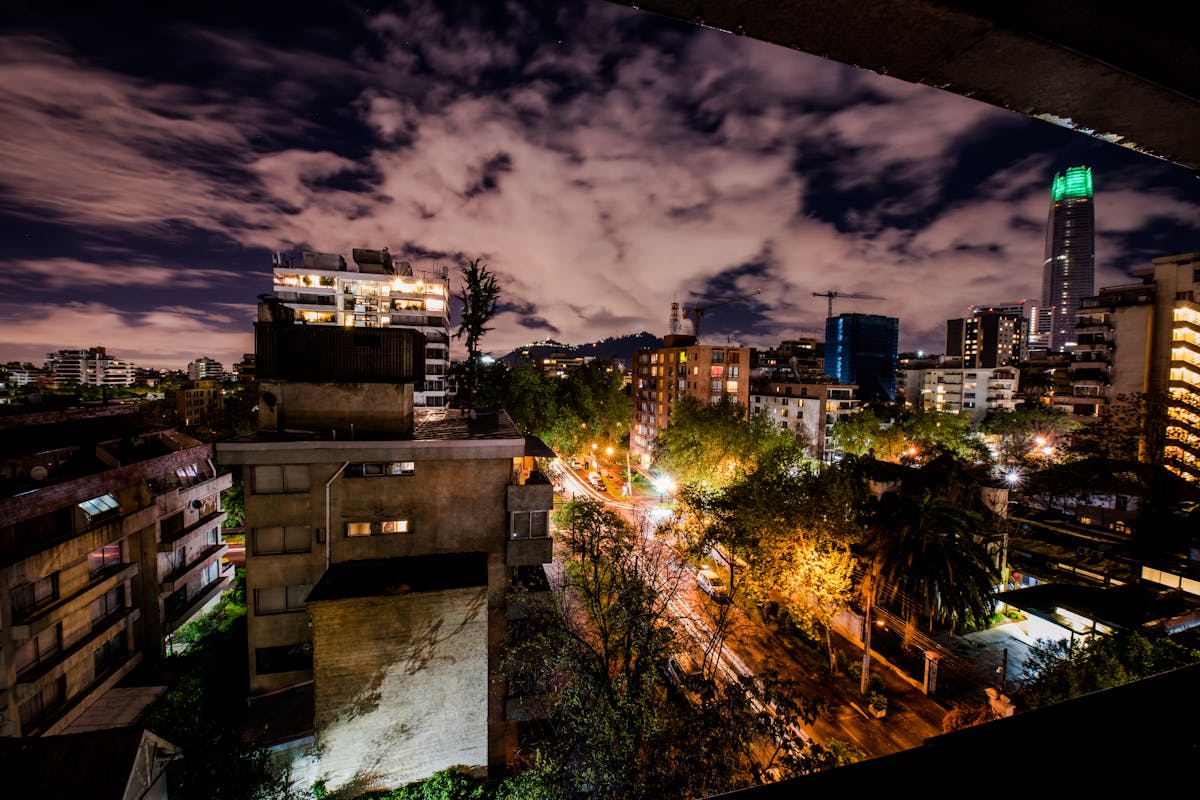 Santiago Chile street scene with pedestrians walking past colonial-era buildings on a sunny day