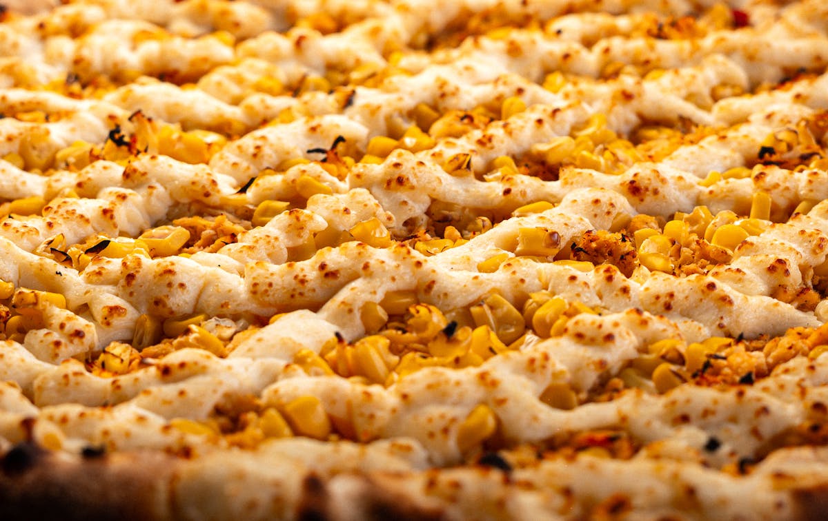 Baked corn and cheese casserole with golden crust in a dish