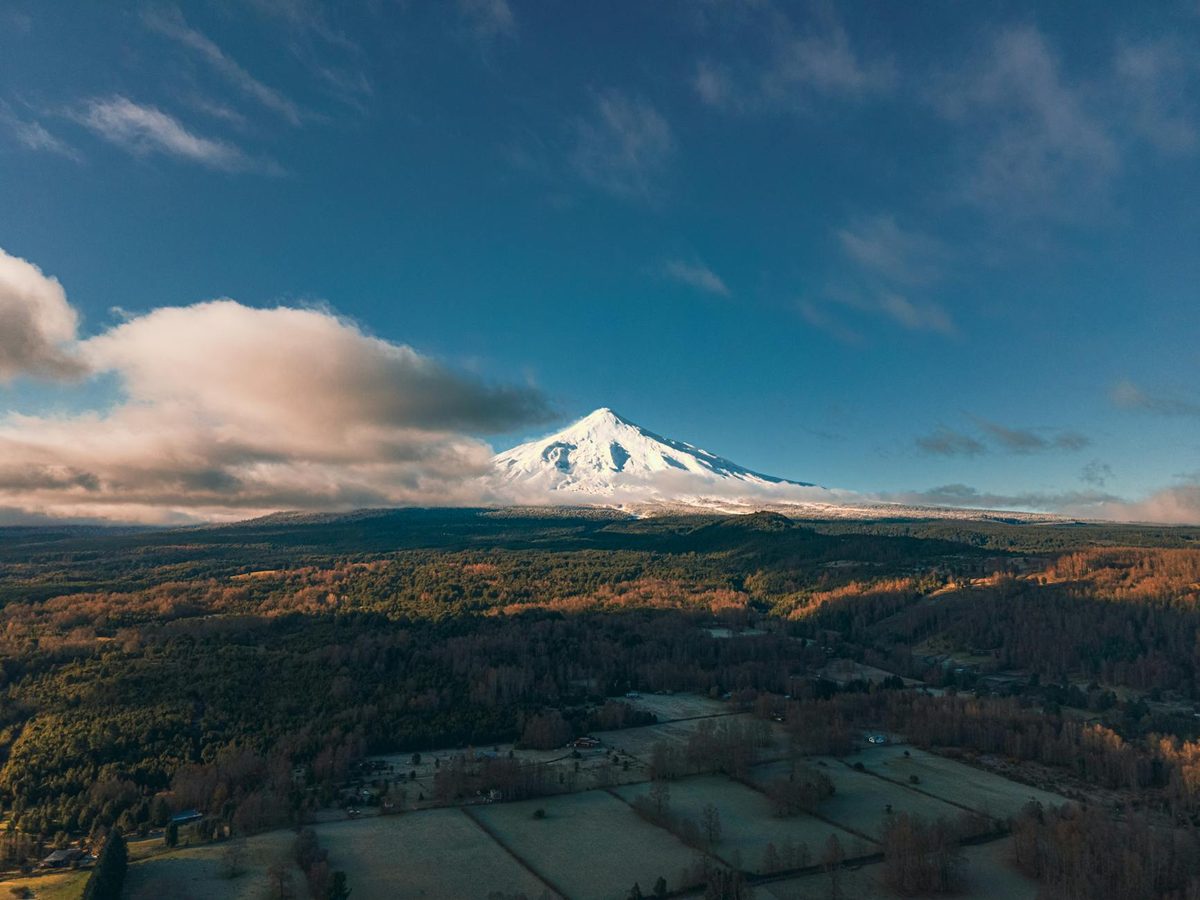 Aerial view of Villarrica Volcano with snow and forests