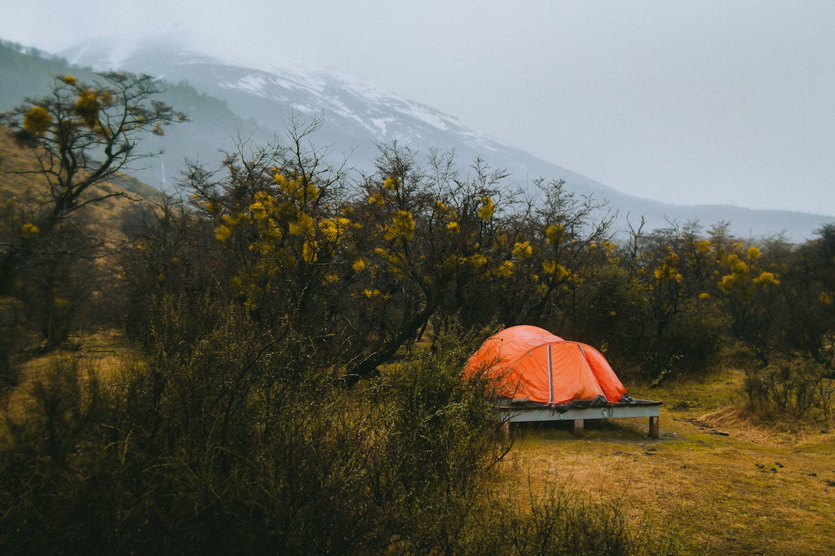 Camping tent with Torres del Paine mountains visible in the background at golden hour