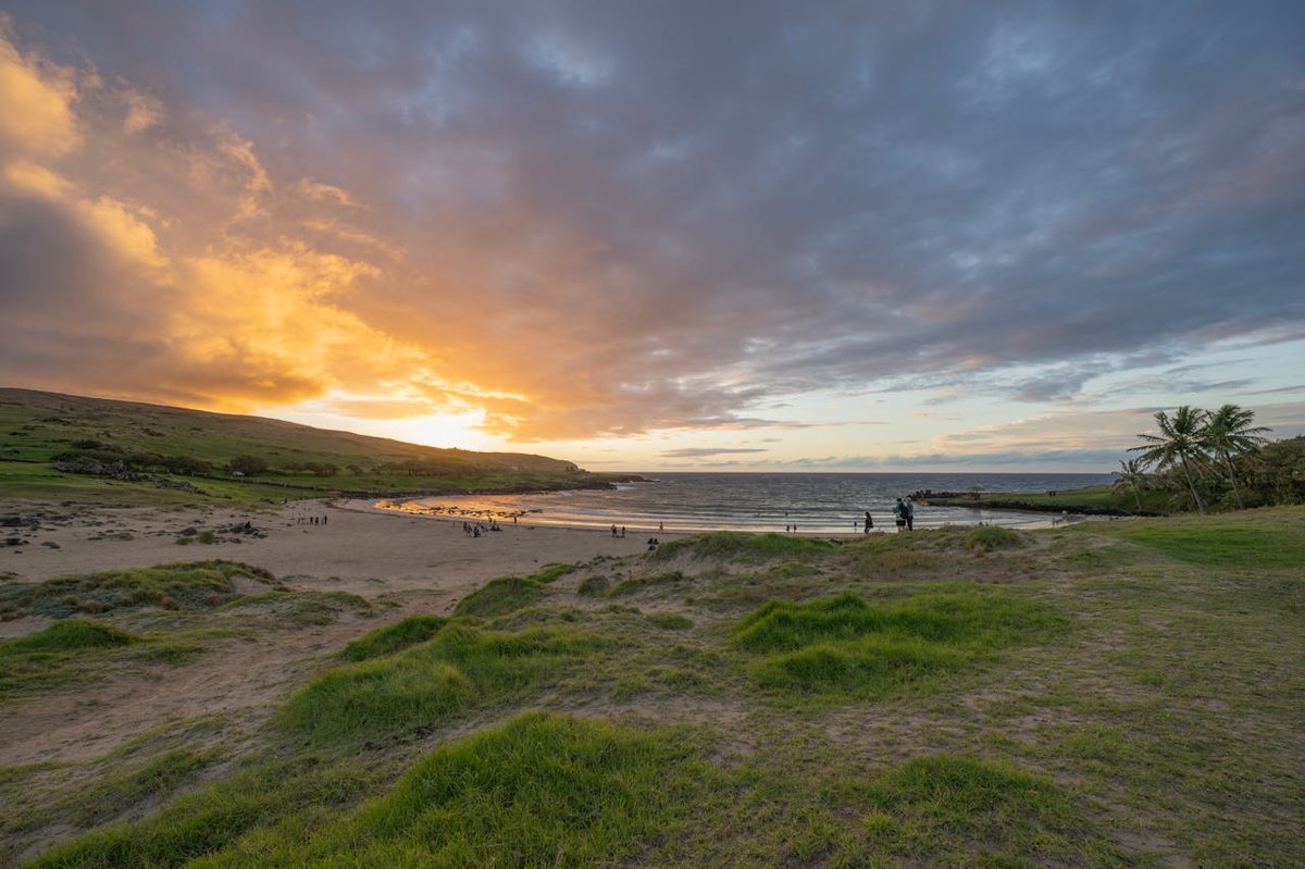 Sunset view at Anakena Beach on Easter Island with warm golden light over the ocean