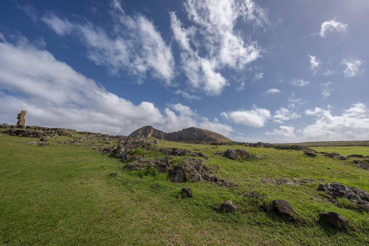 Moai statue at Rano Raraku quarry on Easter Island surrounded by green landscape