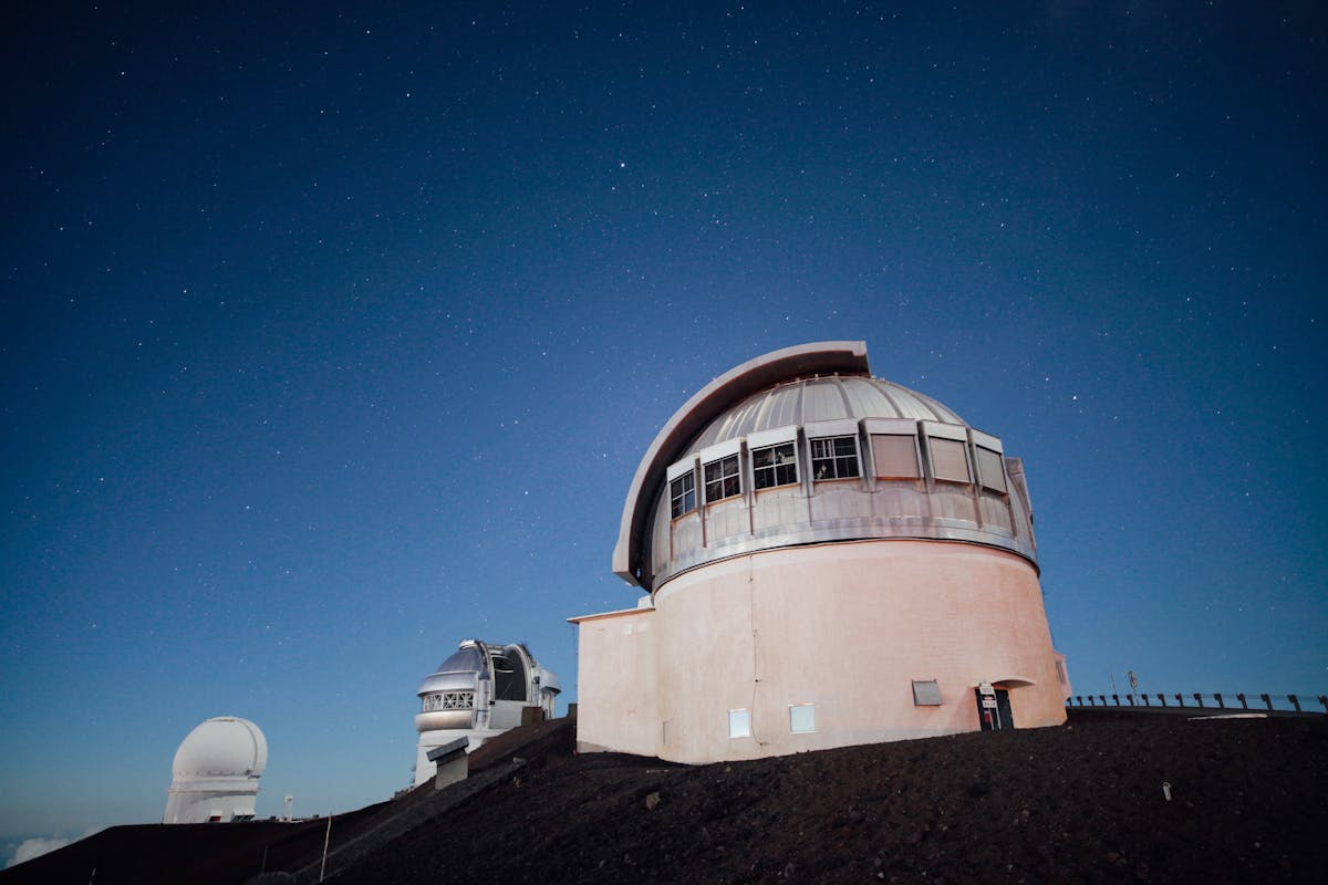 An observatory dome under a clear starry night sky