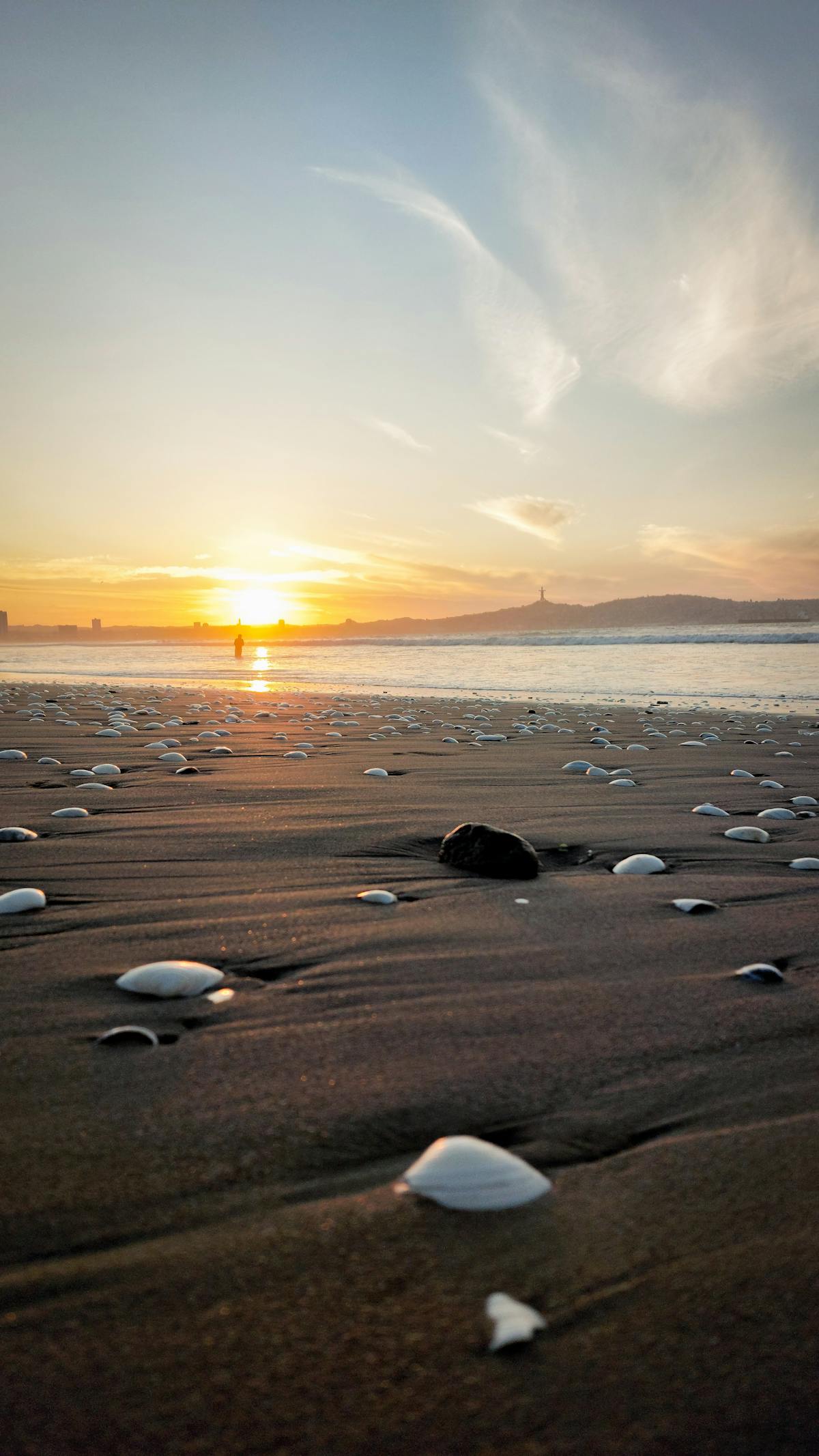 Sunset over the beach at La Serena, Chile with warm orange and pink tones reflecting on the water