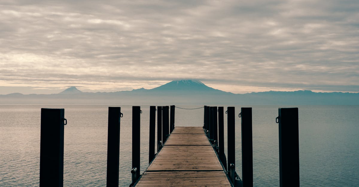 Osorno Volcano seen from a pier in Frutillar, Chile, with the lake stretching toward the snow-capped peak
