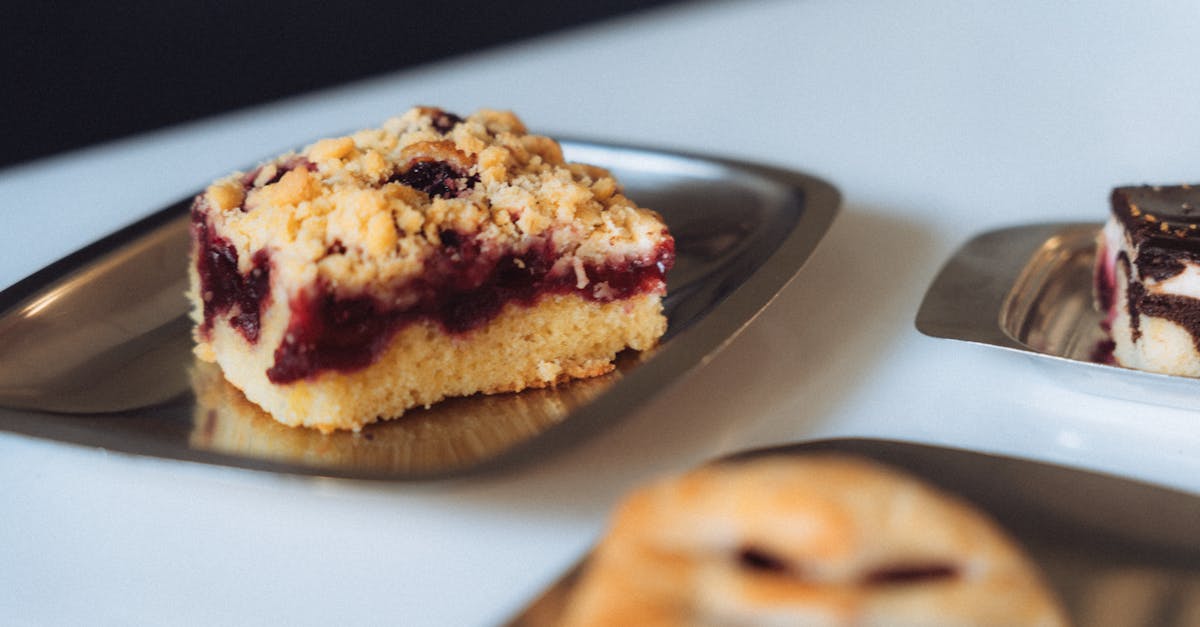 Close-up of a slice of berry streuselkuchen with crumble topping on a plate