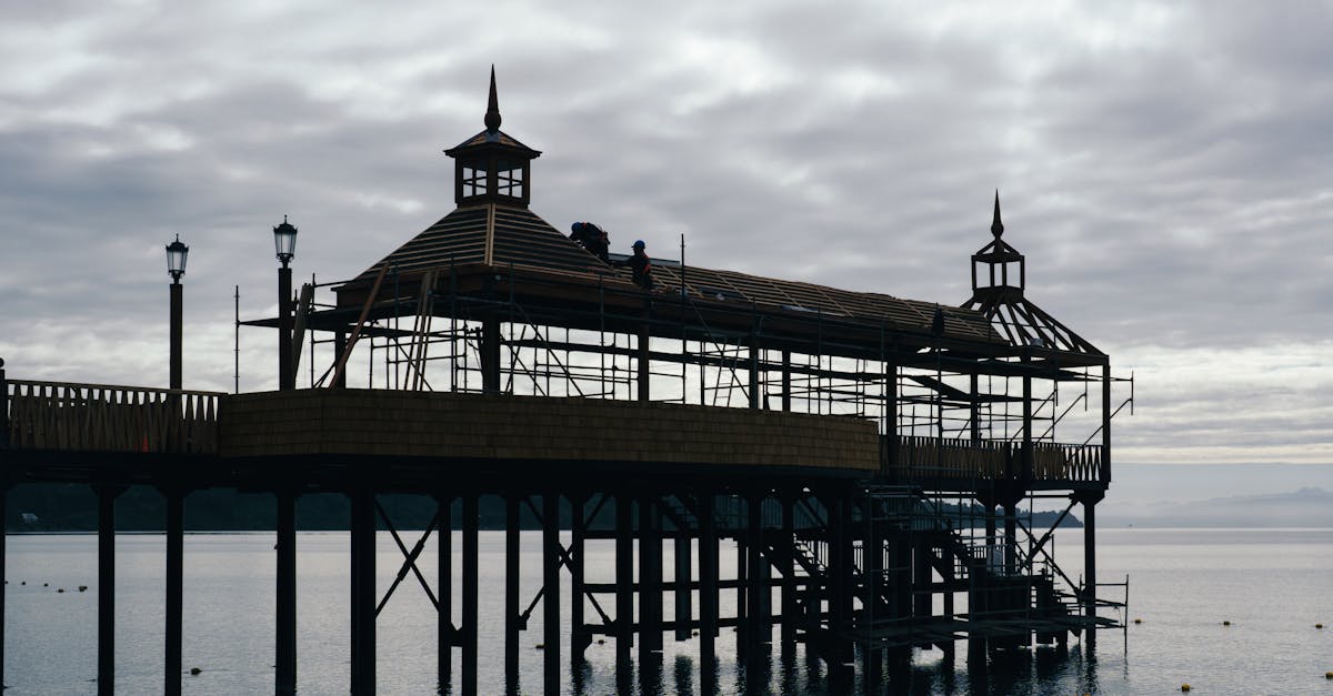 Scenic waterfront pier in Frutillar, Chile, with calm lake waters under overcast skies
