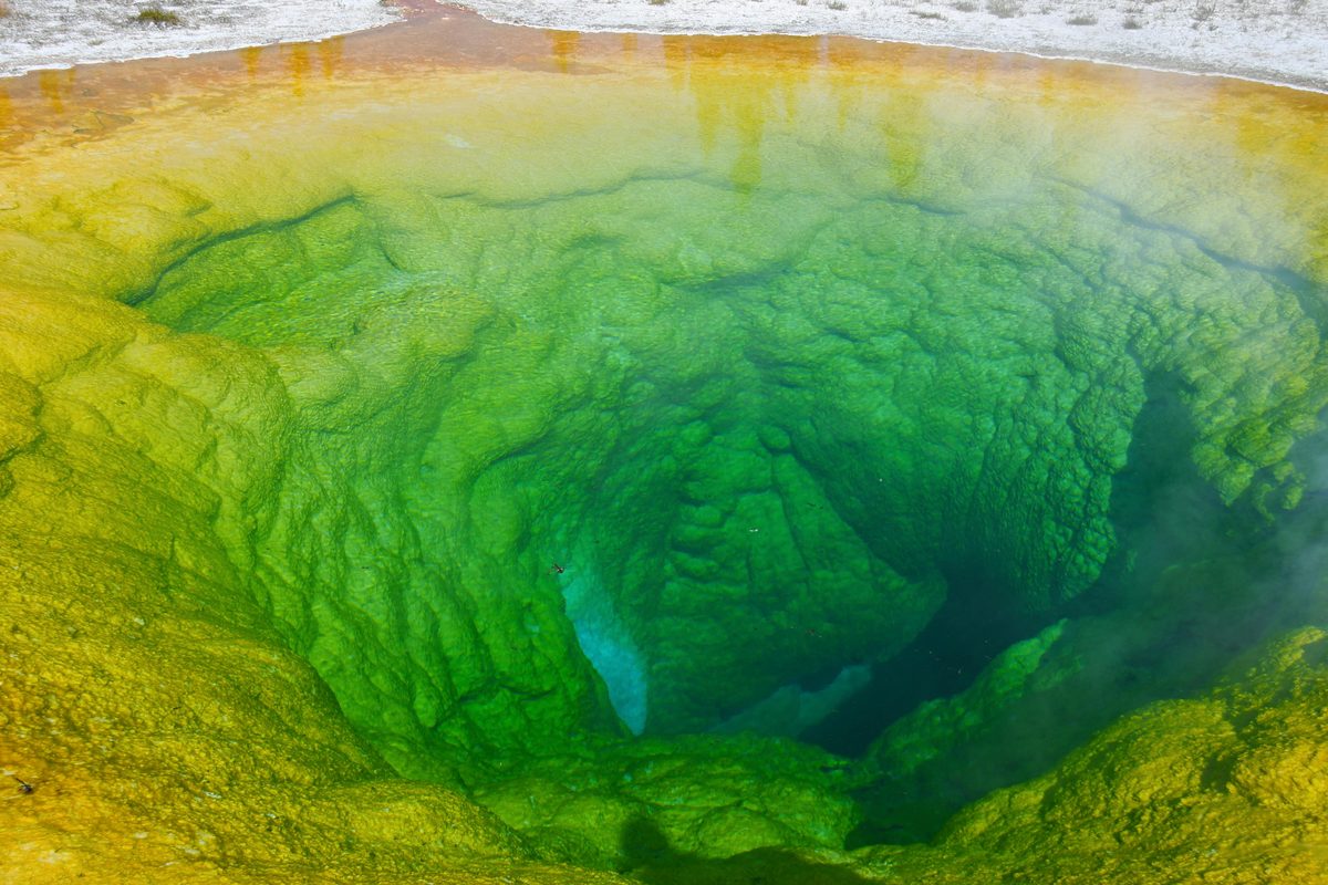 Colorful geothermal pool with vivid mineral deposits in a natural setting