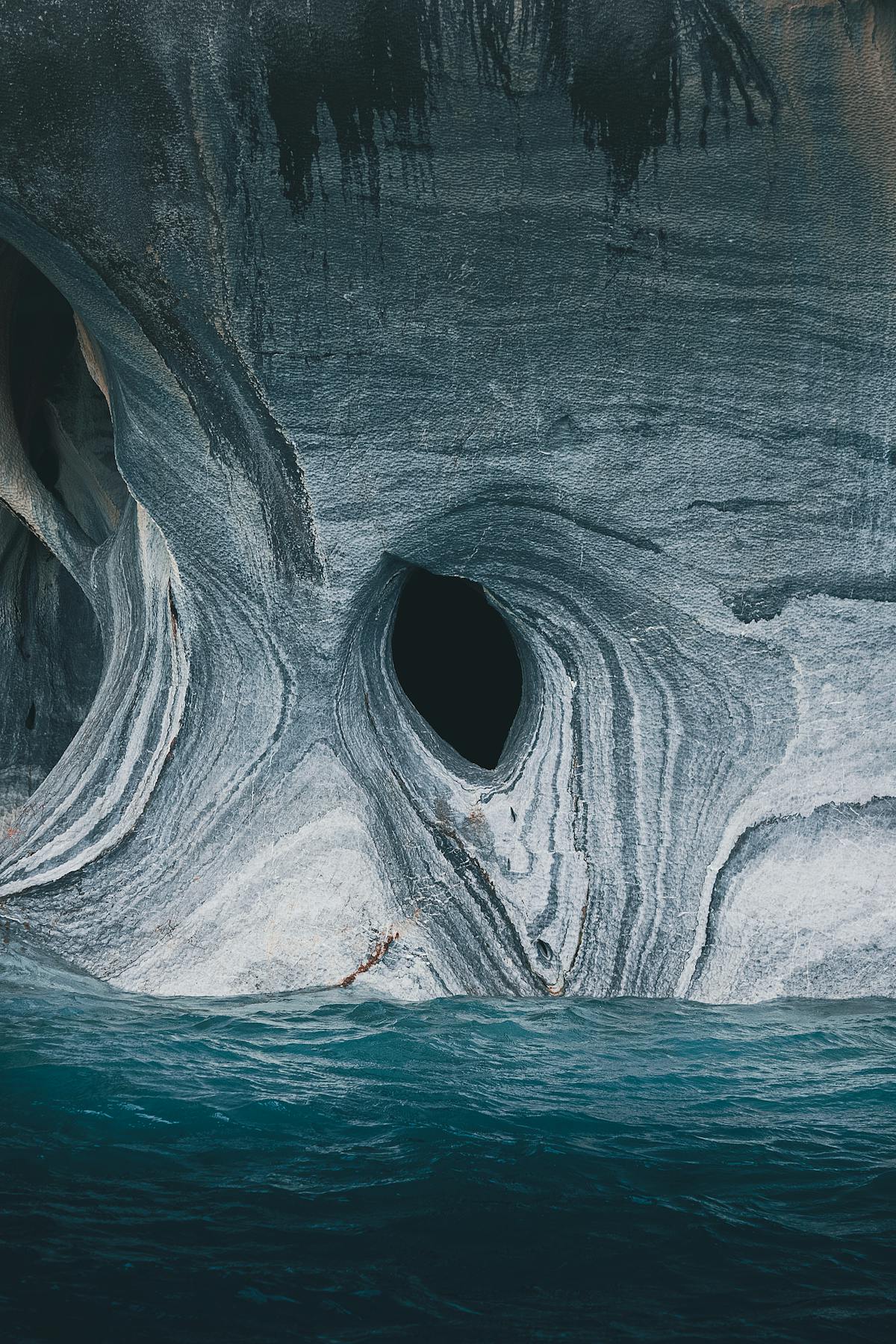 Marble formations emerging from bright turquoise water showing the effect of glacial sediment