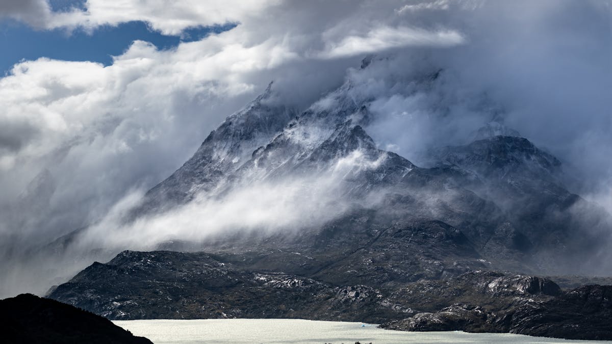 Dramatic misty mountains in southern Chile with moody clouds and rugged peaks