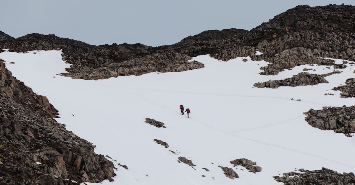 Two hikers ascending a snowy mountain slope in Chilean Patagonia