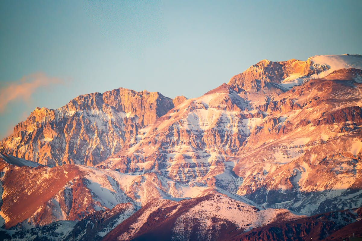 Golden light over the Andes mountains near Santiago Chile with hazy sky and layered ridges