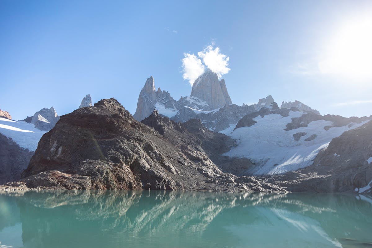 Majestic snowcapped Fitz Roy mountain range reflecting in a serene Patagonian lake