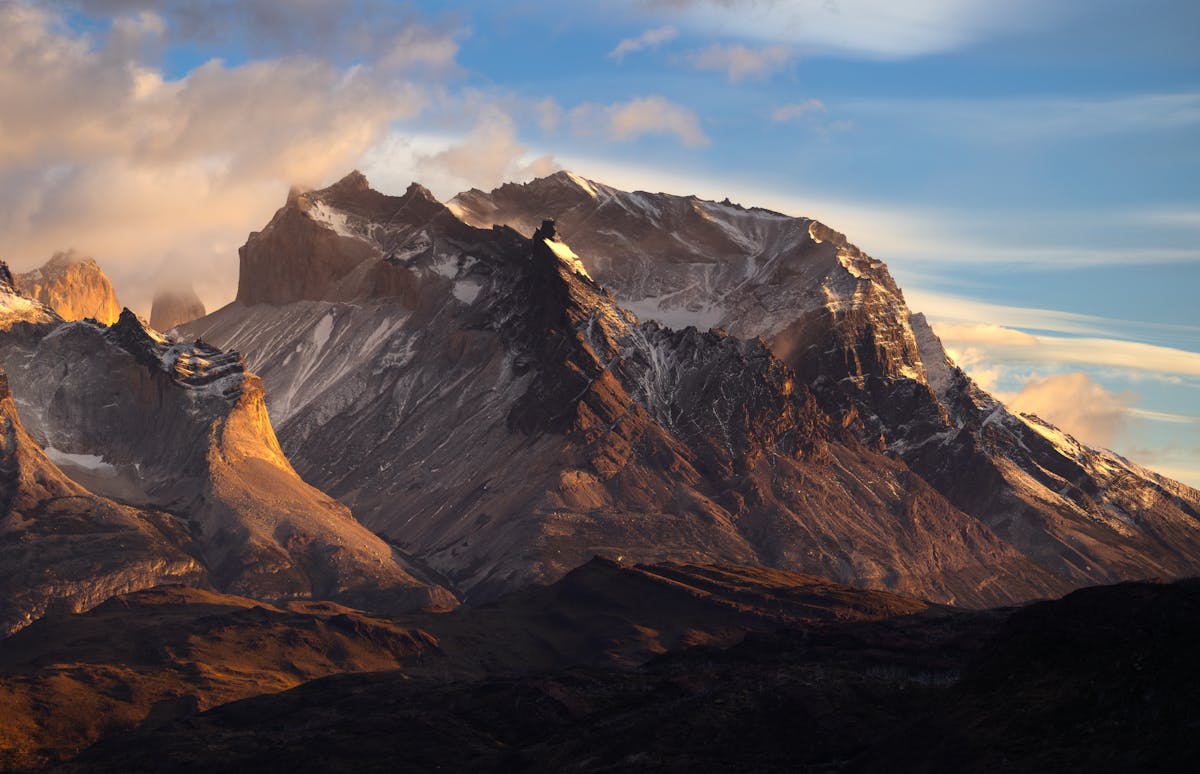 Sunrise over Torres del Paine peaks with orange and pink light on granite towers