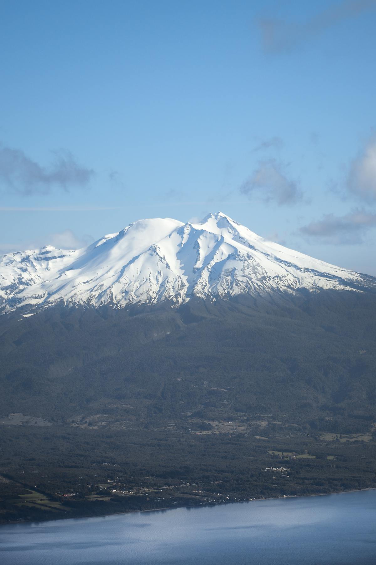 Snow-capped Calbuco Volcano against a clear blue sky in Los Lagos, Chile