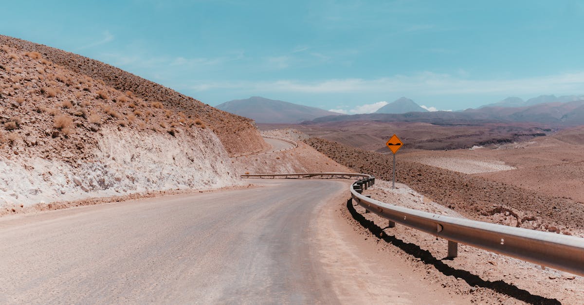 Straight desert road cutting through barren landscape in the Atacama region
