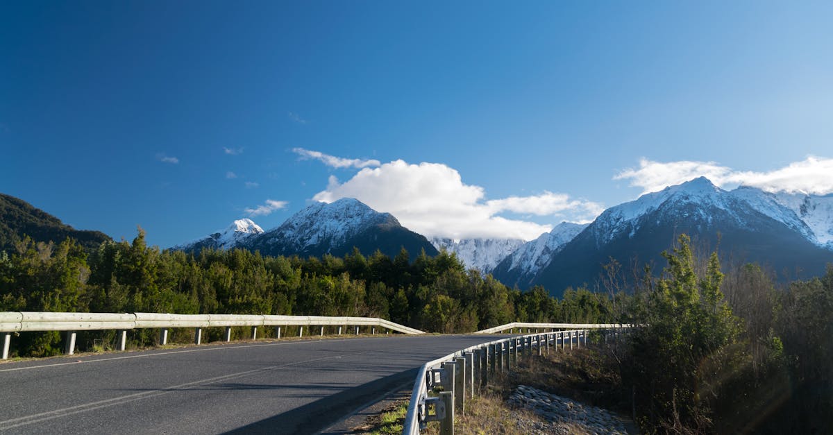 Snow-capped mountains rising above forested valleys along the Carretera Austral