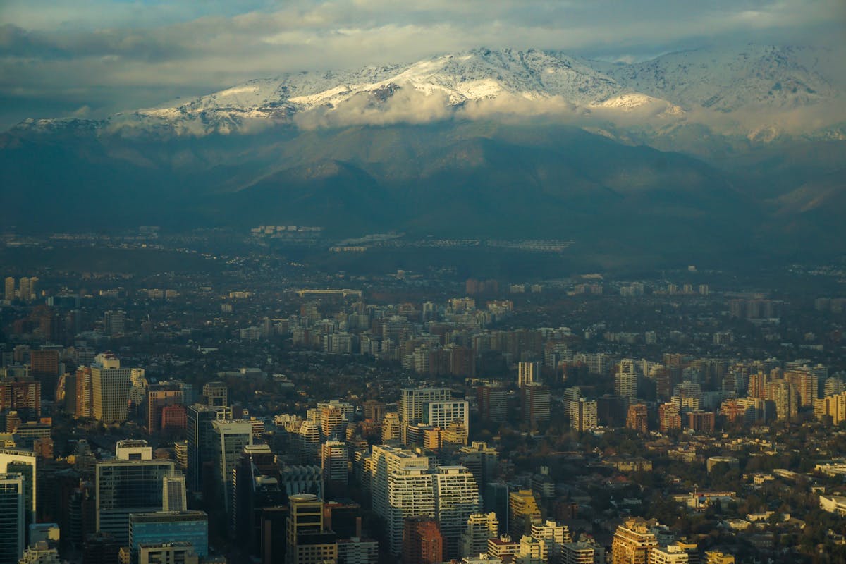 Aerial view of Santiago cityscape with the Andes mountains in the background at sunset