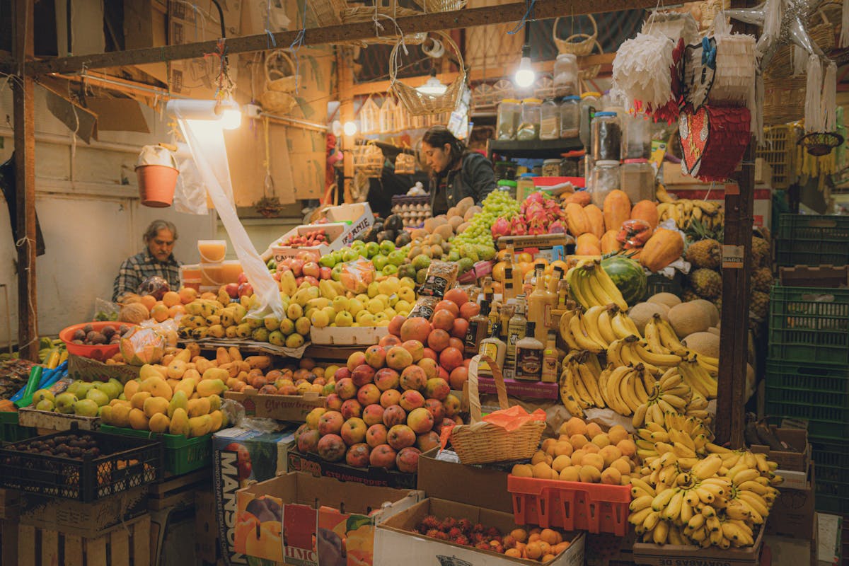 Colorful fruit stall in a Latin American market with fresh produce stacked in rows