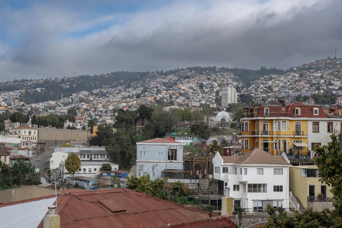 Colorful hillside houses in Valparaiso Chile under cloudy skies