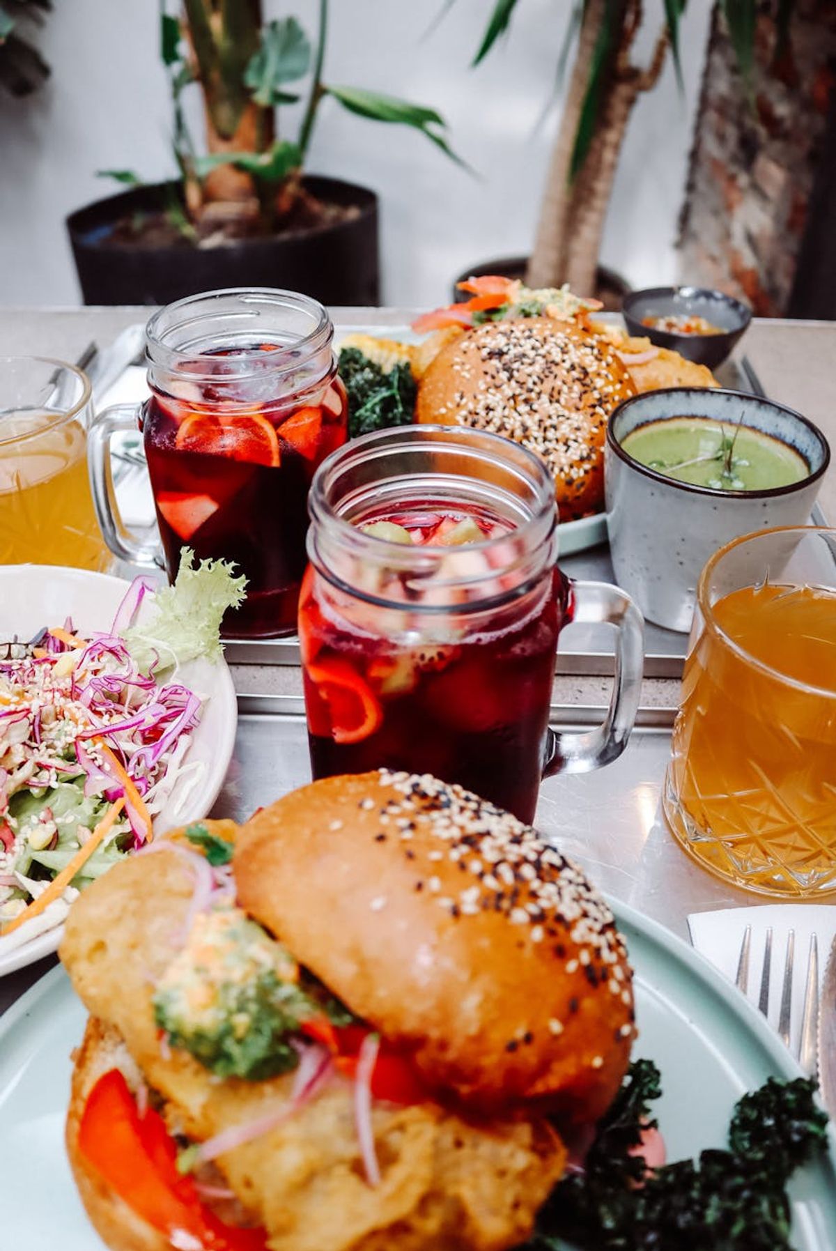 Colorful meal with burgers, sangria, and salad at a restaurant table in Santiago Chile