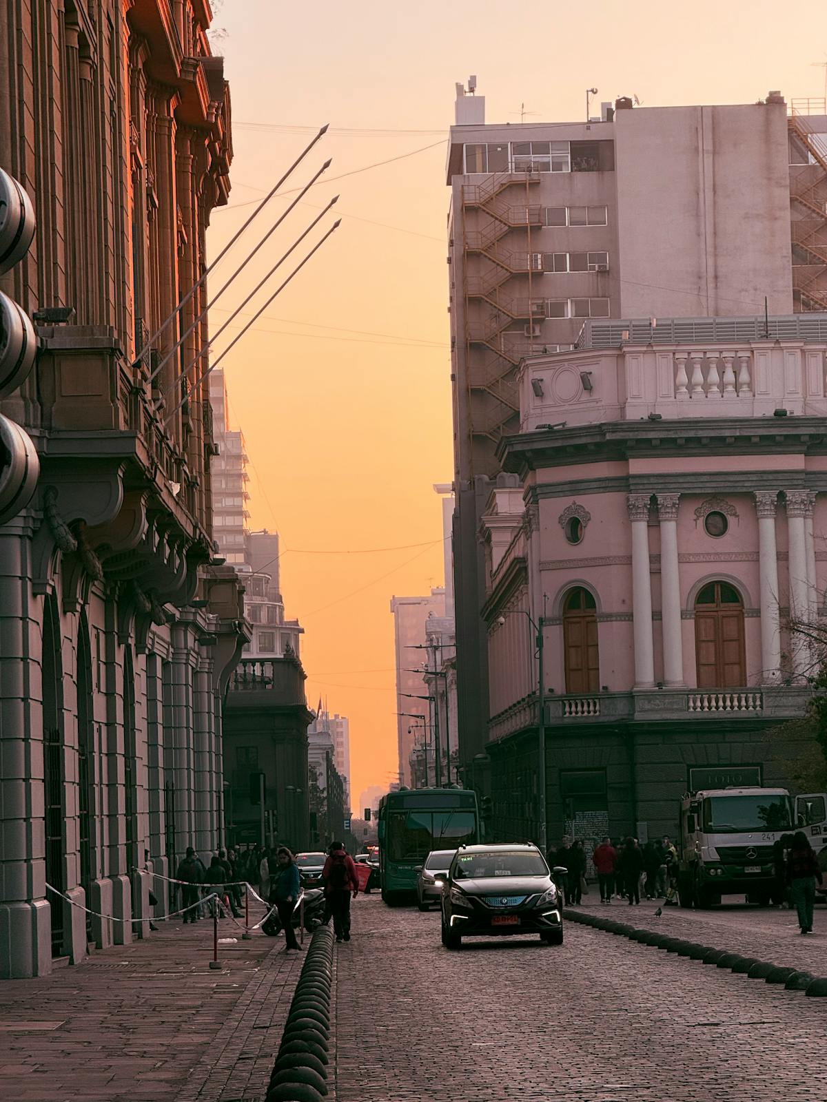 Santiago city street at sunset with historic buildings and warm lighting