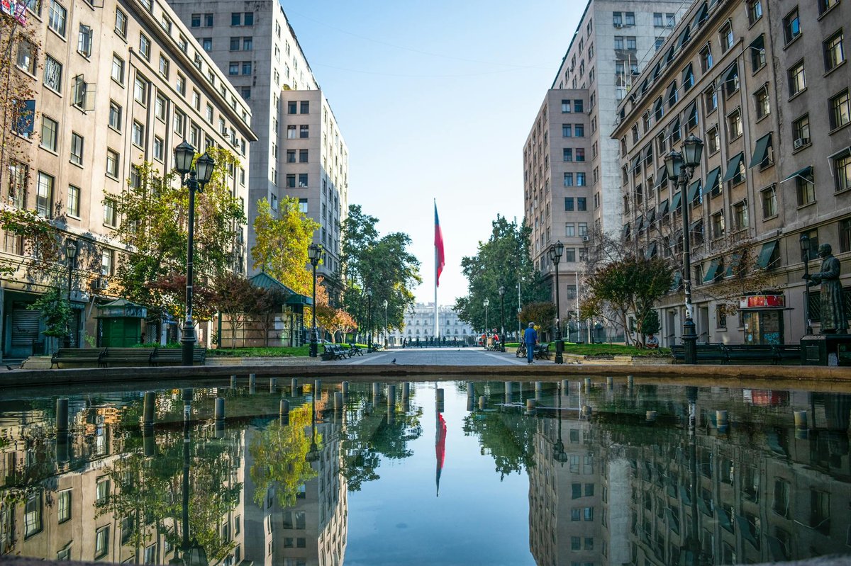 Historic plaza in Santiago Chile with a Chilean flag and classical architecture