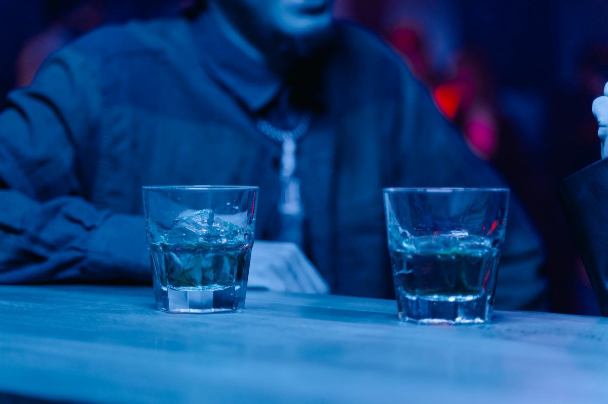 Interior of a dimly lit bar with drinks on the counter