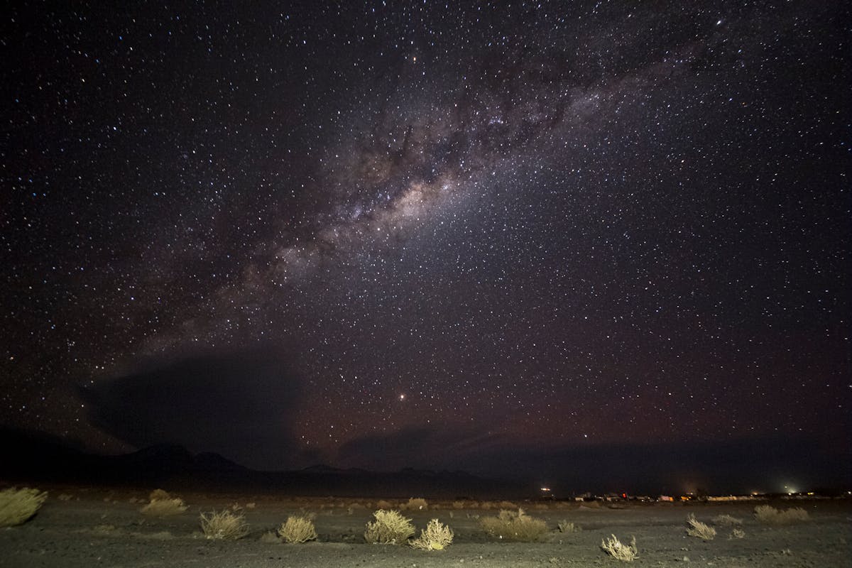 The Milky Way stretching across the night sky over the desert landscape in San Pedro de Atacama Chile