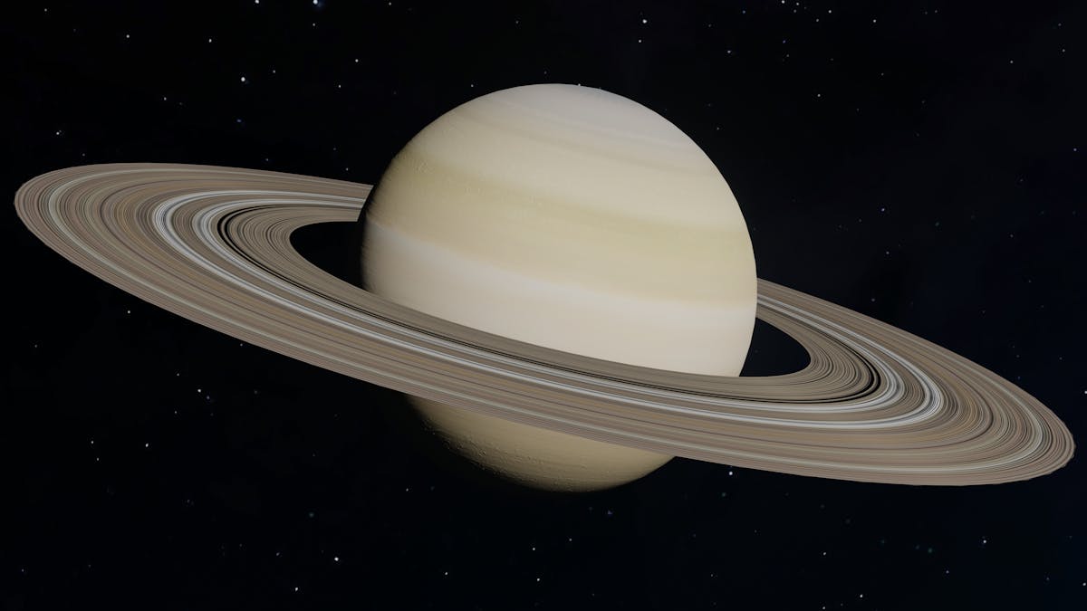 Detailed view of Saturn showing its rings against a dark background as seen through a telescope