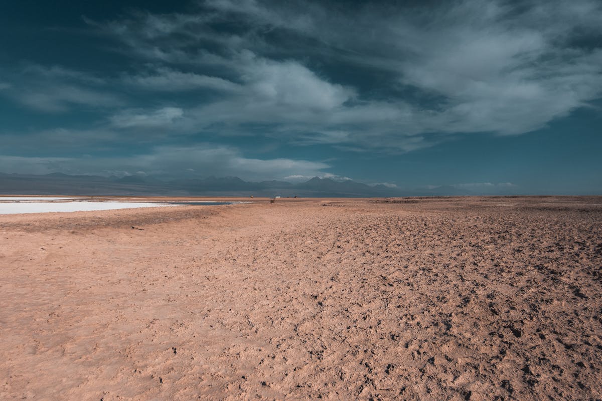 Vast arid landscape of the Atacama Desert under clear blue sky showing the extreme dryness of the terrain