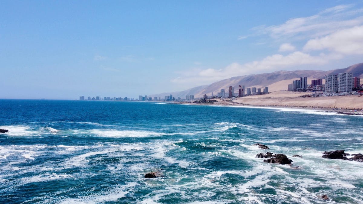 Panoramic view of the Iquique coastline with city skyline under blue sky