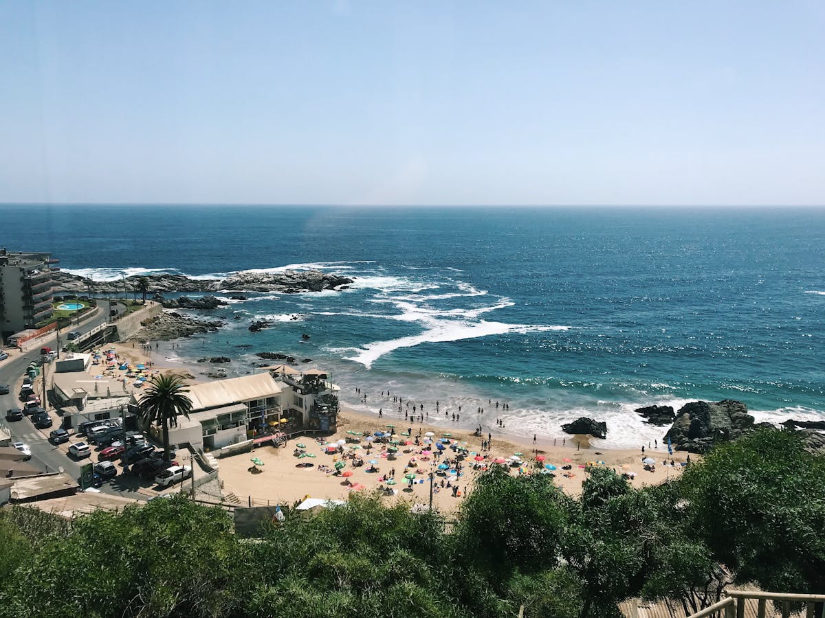 Busy beach in Viña del Mar with sweeping coastline and blue ocean
