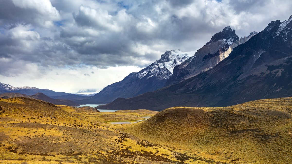Dramatic mountain landscape of Torres del Paine under heavy clouds in Patagonia