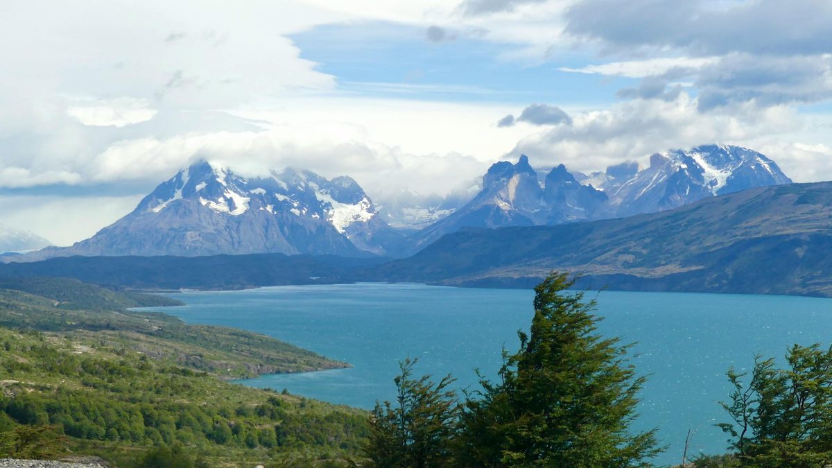 Panoramic view of Torres del Paine mountains reflected in a lake