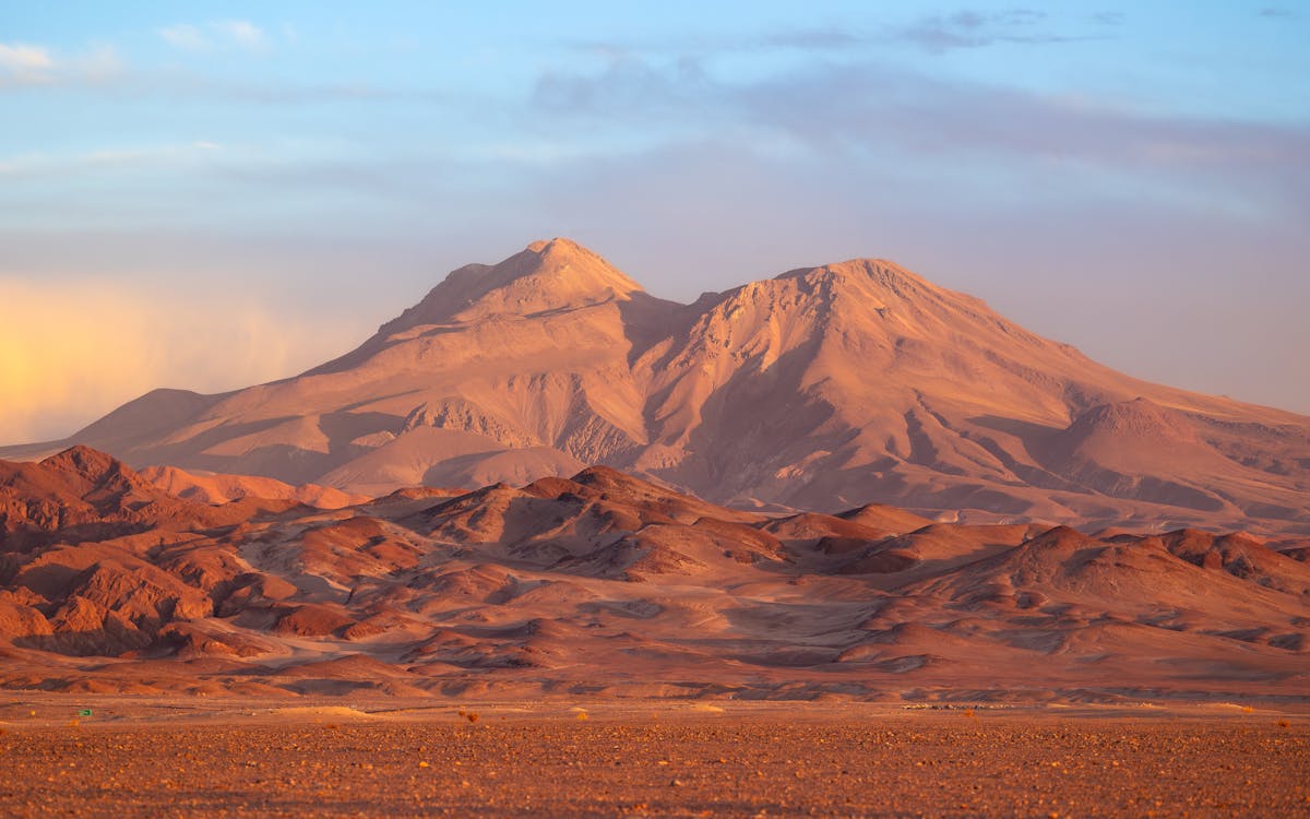 Atacama Desert mountains glowing at sunset under a colorful sky