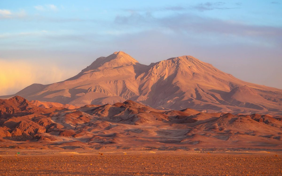 Mountains in the Atacama Desert at sunset with golden light on ridges