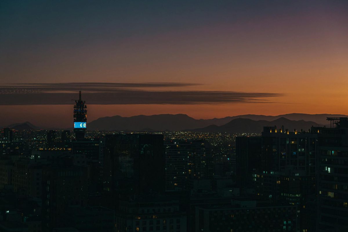 Twilight view of Santiago skyline with silhouetted skyscrapers and mountains